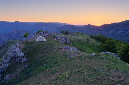 Mountain landscape with a beautiful sunset  Camping in the outdoors with a tentの写真素材