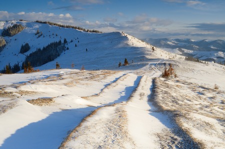 Winter landscape with a road in the mountains  Strong windの写真素材