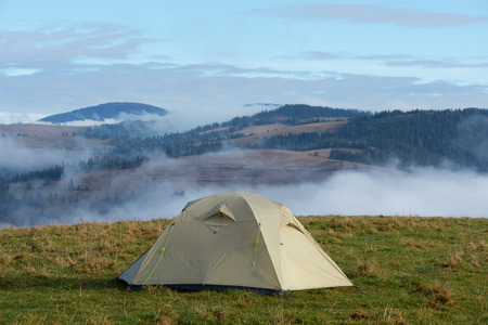 Mountain landscape with tourist tent on a meadowの写真素材