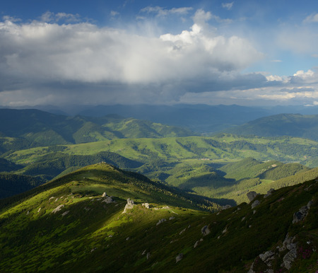 Summer landscape in the mountains. Beautiful clouds over the hills. Carpathians, Ukraine, Europeの写真素材