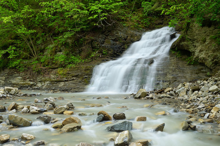 Spring landscape with the river. Beautiful waterfall in the mountainsの写真素材