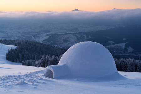 Snow igloo on a mountain hill. Winter landscape. Adventures in the winter campaignの写真素材