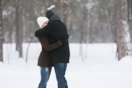 Embrace of couples in love. Romantic date in winter park. Photo in defocusingの写真素材
