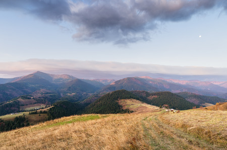 Autumn Landscape in the mountain village. The road on the ridge. Carpathians, Ukraine, Europeの写真素材