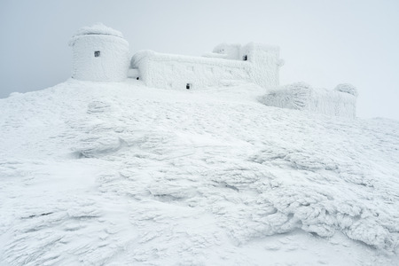 Winter landscape with a beautiful texture of the snow. The old observatory on the top of the...