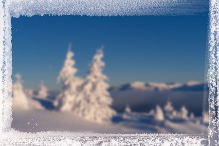 Christmas background for design. Blurred picture of the nature and frame of frost.の写真素材