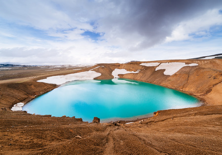 Caldera volcano with turquoise water. Lake Krafla, a tourist attraction of Iceland. Geothermal valley Leirhnjukurの写真素材
