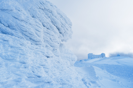 Winter landscape in the mountains. The old observatory on top. Beautiful texture of snow and neve. Carpathians, Ukraine, Europeの写真素材