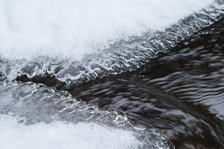 River under the ice and snow. Beautiful iciclesの写真素材
