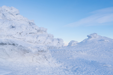 Hoarfrost on a rock in the mountains. Winter landscape a cloudy day. Severe weatherの写真素材