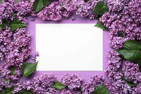 Frame of flowers and leaves with blank sheet for notes. Decor of lilac flowersの写真素材