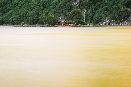 Norway, Lovrafjorden, July 05, 2017: lonely house with a manor on a small island in the fjordのeditorial素材