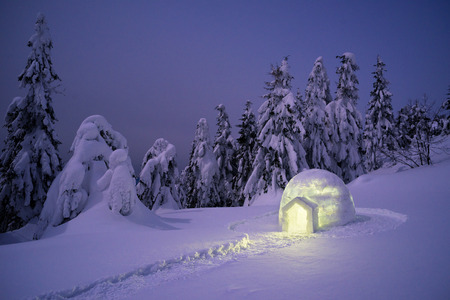 Snow eskimo igloo. Mountain hiking in winter. Night landscape with shelter for extreme touristsの写真素材