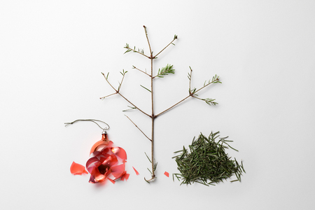 Christmas Break Is Over. Broken Christmas ball and fallen spruce needles on white background. Flat lay, top viewの写真素材