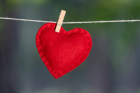Valentine's day card with red heart on blurred backgroundの写真素材