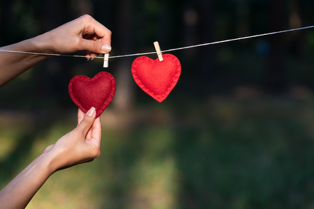 Concept on the theme of love and love confession. Valentine's day card with a pair of red hearts. Ð¡opy space for greeting or advertising textの写真素材