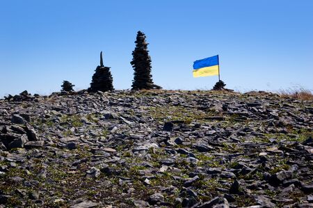 Flag of Ukraine on the top of the Carpathians Mountain. Summer adventureの写真素材
