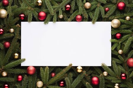 Christmas or New Year decoration background with copy space. Festive frame of fir branches and Christmas ballsの写真素材