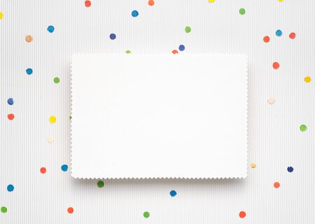 Light Christmas background with festive confetti. White paper sheet with copy space for textの写真素材