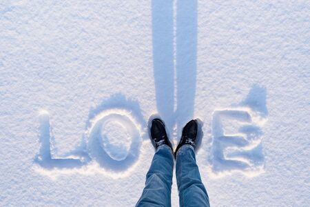 Valentine's Day card with the word love in the snow and copy spaceの写真素材