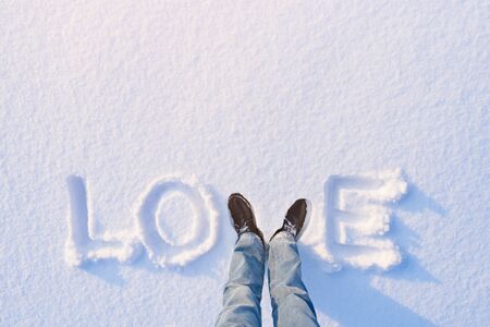 Original background for a card for Valentine's Day. The word "love" written in the snowの写真素材
