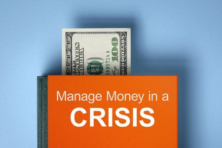 Managing Money in a Crisis. Book about financial literacy. Finance Savings Conceptの写真素材