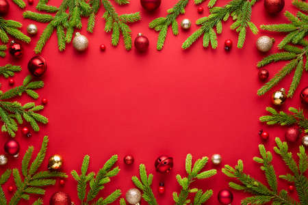 Christmas frame on red background. Top view with copy space for greetings textの写真素材