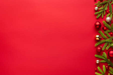 Christmas and new year red background with holiday decoration. Decorative frame with copy space for message. Top view, flat layの写真素材