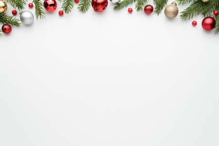 White christmas tree background with fir branches and decorations. Happy holidays frame with copy space for festive text. Top view, flat layの写真素材