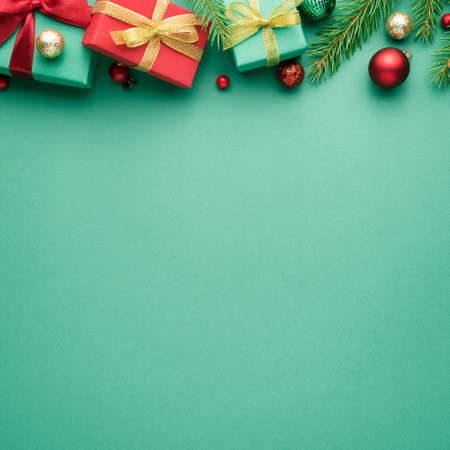 Square Merry Christmas and Happy New Year card with fir decorations on turquoise background. Blank for advertising text with copy space. Top view, flat layの写真素材