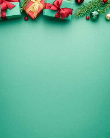 Christmas or New Year turquoise background with fir border. Decoration frame with copy space for text. Top view, flat layの写真素材