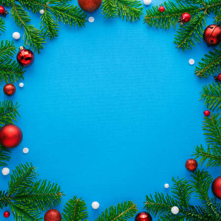 Blue christmas card with round frame decorated with festive ornaments. Copy space for festive text....