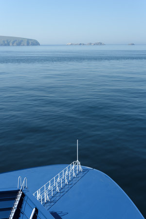 Marine background with ship deck and sea view in blue monochrome color and copy spaceの写真素材