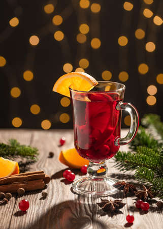 Christmas card with mulled wine on stunning lights background near Christmas treeの写真素材