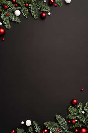 Christmas template for design with festive frame with candy cane and Christmas balls on black backgroundの写真素材