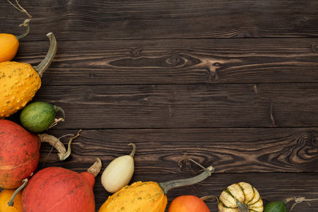 Autumn banner with a frame of pumpkin harvest on the background of an old rustic tableの写真素材