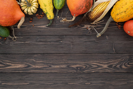 Autumn background with pumpkin border on vintage wooden backgroundの写真素材
