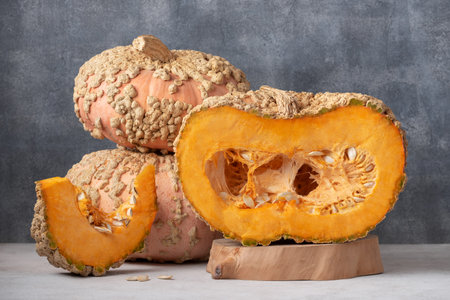 Heirloom Galeux D Eysines Pumpkin With Fresh Orange Flesh And Seeds Displayed On Kitchen Tableの写真素材