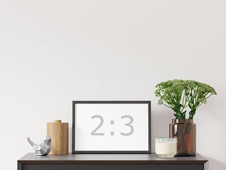 Empty horizontal frame 2: 3 on white wall with black dresser, green plant in brown glass vase and decor - close up image.の写真素材