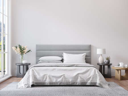 Empty white wall for print or poster mockup in modern neutral gray bedroom interior with wood floor, rug with geometric pattern, bedside tables, lamps, decor and plants.の写真素材