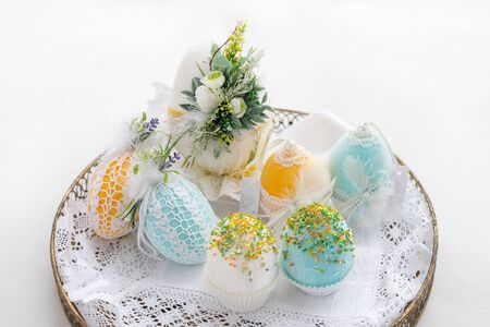 Easter composition of eggs in a basket, handmade, prepared for the holiday of Easter, on a white...