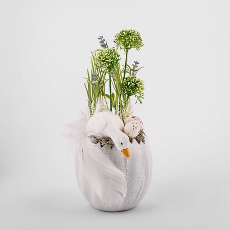 Handmade Easter composition - duck eggs flowers greens prepared for Easter, porcelain clay material, on a white backgroundの写真素材