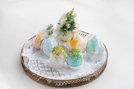 Easter composition of eggs in a basket, handmade, prepared for the holiday of Easter, on a white backgroundの写真素材
