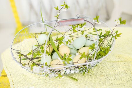 chicken and quail eggs in a basket, preparing for Easterの写真素材