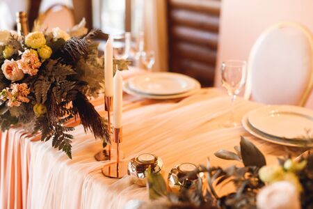 The presidium of the newlyweds at the wedding. Table for the bride and groom with fresh and white...