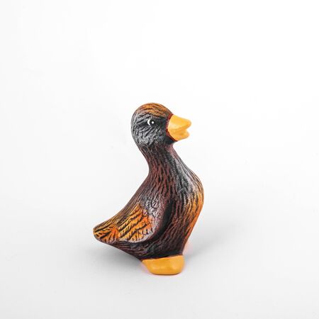 Ceramic duck look away. Isolated brown and yellow duck for gardenの写真素材