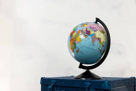 Travel or turism concept. Isolated globe on blue suitcase. Copy space