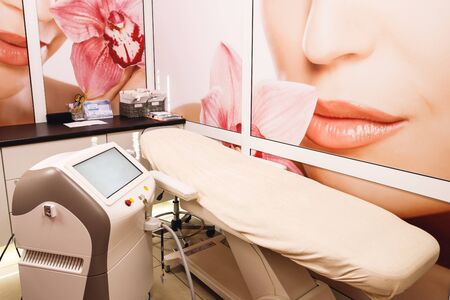 Modern equipment in a cosmetology. Modern pink brown cosmetologist cabinet. Interior of beauty center. Concept of Beauty industryの写真素材