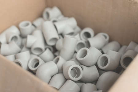 Fittings for installation of water supply from polypropylene in carton. White plastic tees for connecting branches in the water supply systemの写真素材