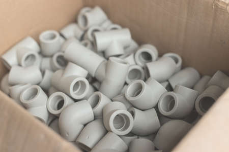 Fittings for installation of water supply from polypropylene in carton. White plastic tees for connecting branches in the water supply systemの写真素材